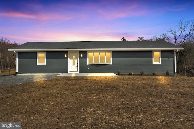 single story home with gravel driveway