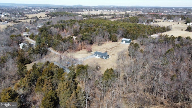 birds eye view of property with a forest view