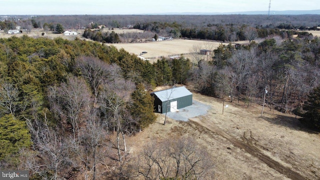 birds eye view of property with a forest view and a rural view