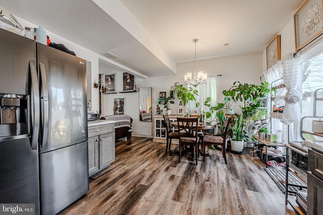 kitchen featuring a healthy amount of sunlight, dark wood-style flooring, and stainless steel fridge with ice dispenser