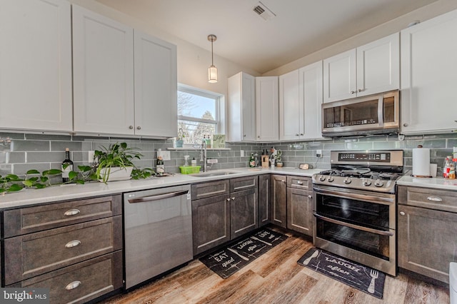 kitchen with light countertops, appliances with stainless steel finishes, and a sink