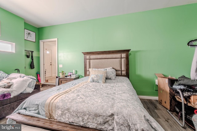 bedroom with wood finished floors and baseboards