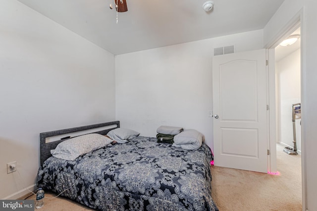 carpeted bedroom featuring visible vents and a ceiling fan