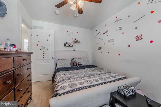 bedroom with a ceiling fan, visible vents, and light colored carpet