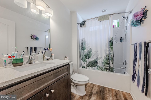 bathroom with toilet, shower / bathtub combination with curtain, wood finished floors, and vanity