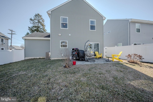 back of house with a yard, central AC unit, and a fenced backyard