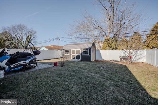 view of yard with an outbuilding, a fenced backyard, a patio, and a shed