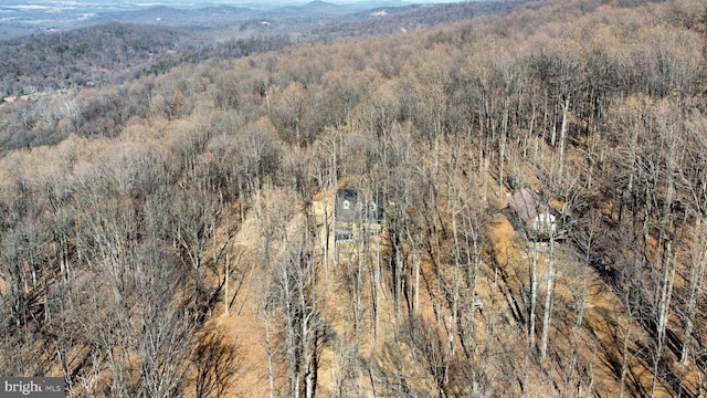 drone / aerial view featuring a mountain view and a wooded view