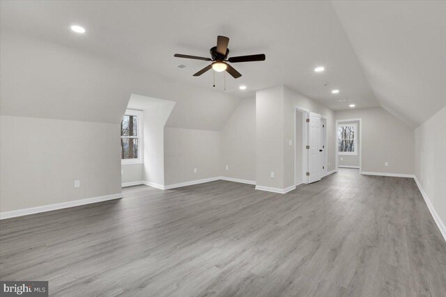 bonus room featuring lofted ceiling, recessed lighting, visible vents, wood finished floors, and baseboards