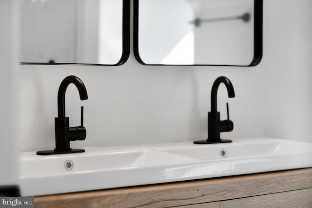 interior details featuring a sink and double vanity