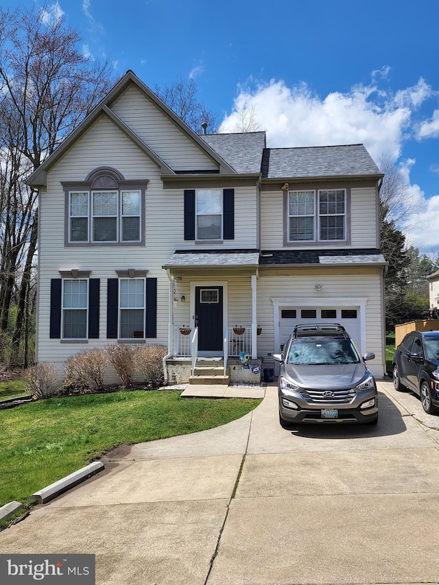 view of front facade featuring a garage, a front yard, and driveway