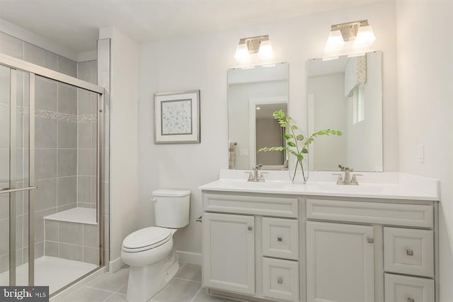 bathroom with a stall shower, a sink, and toilet