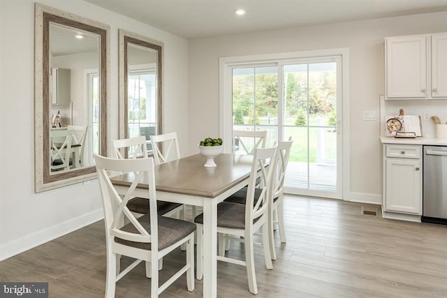 dining area with light wood-style floors, recessed lighting, visible vents, and baseboards