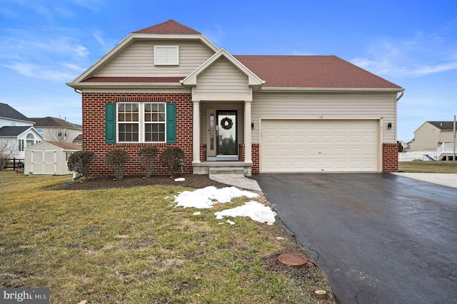 view of front facade featuring driveway, a garage, a front yard, and brick siding