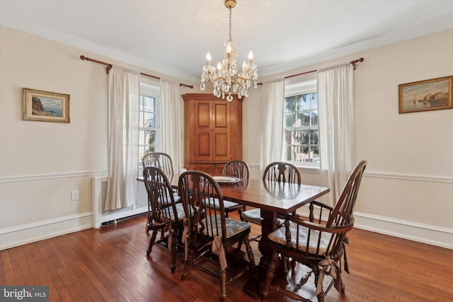 dining area with dark wood-style floors, baseboards, and ornamental molding