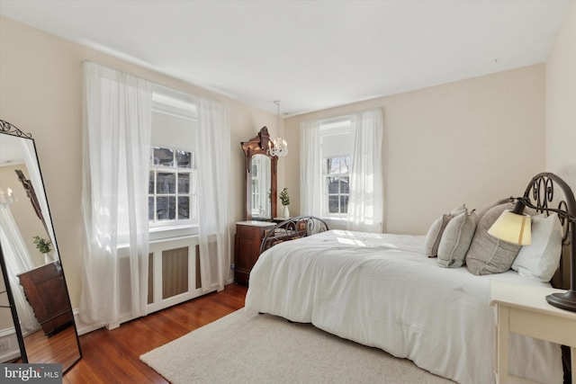 bedroom with dark wood-type flooring