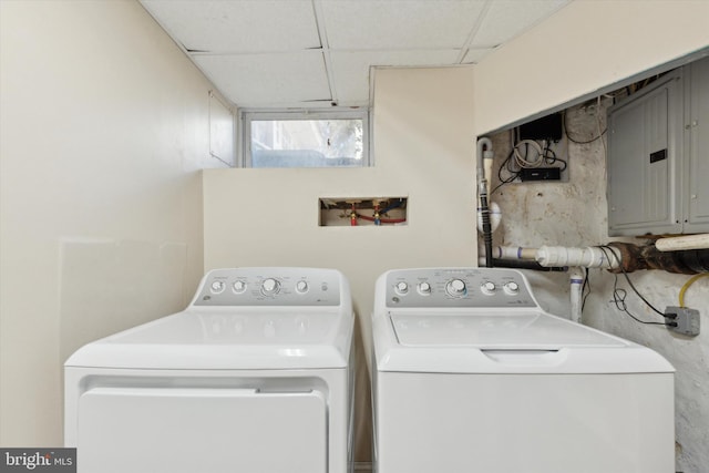 washroom with laundry area, washing machine and dryer, and electric panel