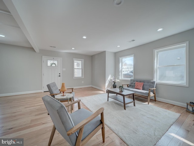 living area featuring recessed lighting, visible vents, baseboards, and light wood-style flooring