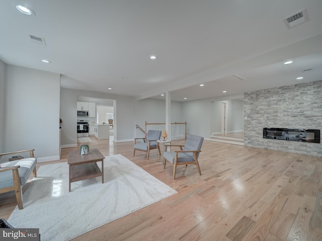 living room featuring recessed lighting, visible vents, and light wood finished floors