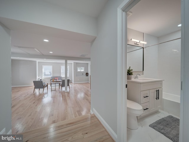 full bath featuring vanity, toilet, wood finished floors, and baseboards