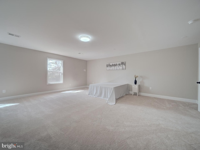 unfurnished bedroom with light colored carpet, visible vents, and baseboards