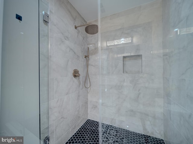 bathroom with a tile shower