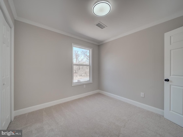 unfurnished bedroom with visible vents, baseboards, ornamental molding, a closet, and carpet flooring