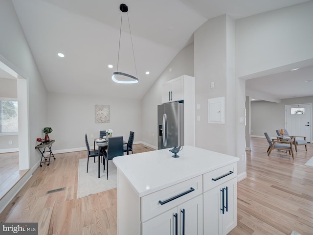 kitchen featuring baseboards, light wood-style floors, white cabinets, and stainless steel refrigerator with ice dispenser