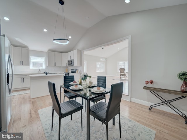 dining room featuring recessed lighting, baseboards, light wood-type flooring, and lofted ceiling