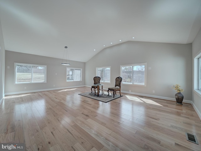 unfurnished room featuring visible vents, baseboards, light wood-type flooring, recessed lighting, and high vaulted ceiling