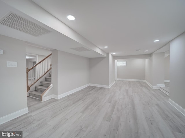 basement featuring wood finished floors, visible vents, baseboards, recessed lighting, and stairs