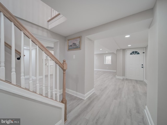 hallway featuring recessed lighting, stairs, baseboards, and wood finished floors