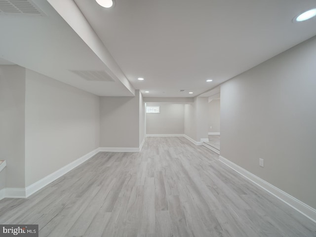 below grade area featuring recessed lighting, wood finished floors, visible vents, and baseboards