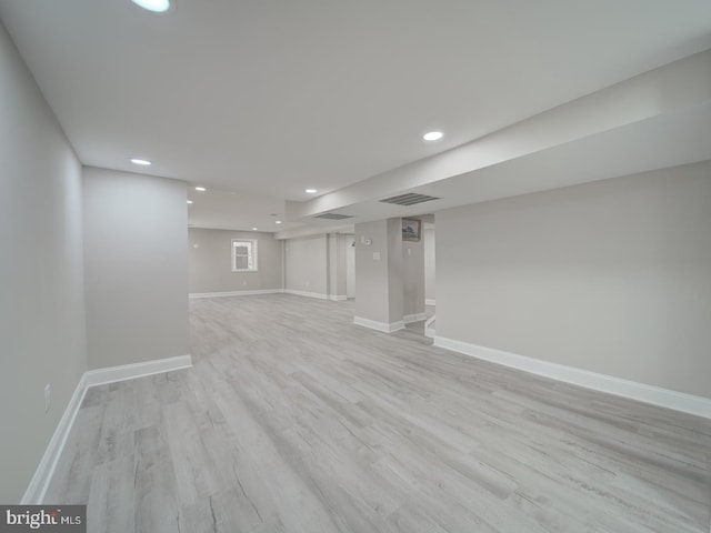 finished basement with recessed lighting, baseboards, and light wood-type flooring