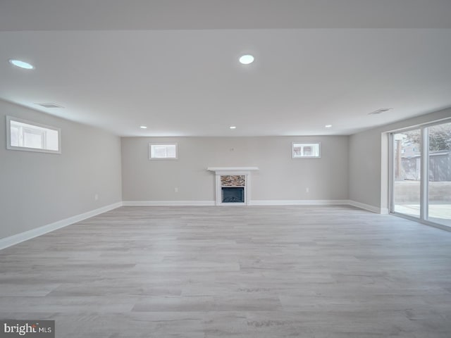 basement with recessed lighting, baseboards, and light wood-style floors