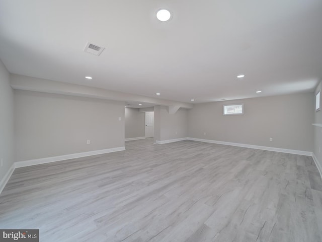 below grade area featuring recessed lighting, visible vents, baseboards, and light wood finished floors