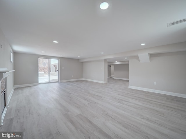 unfurnished living room featuring visible vents, recessed lighting, baseboards, and light wood-style floors