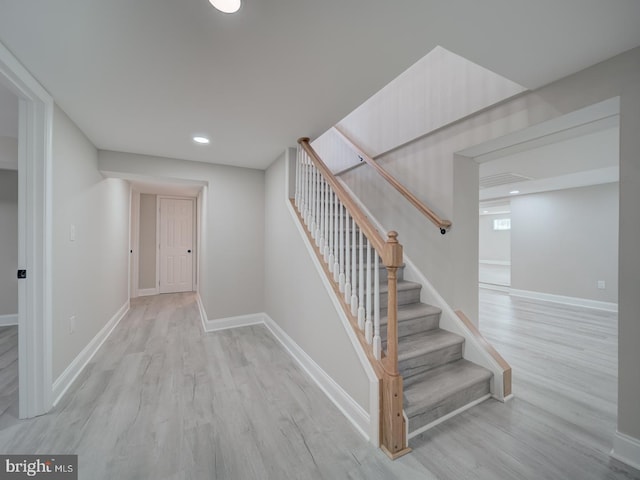 stairs with recessed lighting, baseboards, and wood finished floors