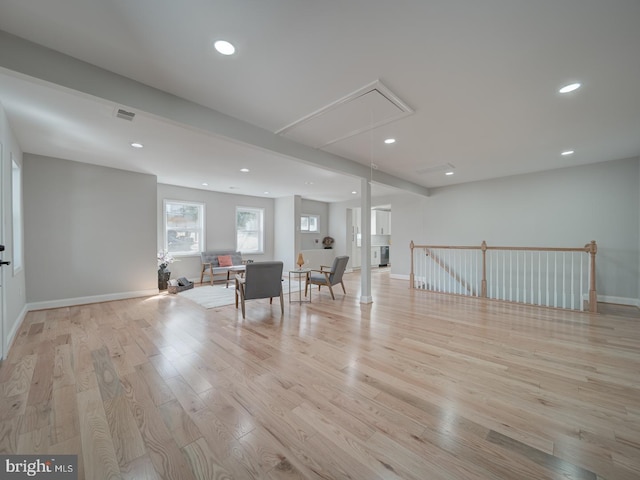 interior space with visible vents, baseboards, attic access, light wood-type flooring, and recessed lighting