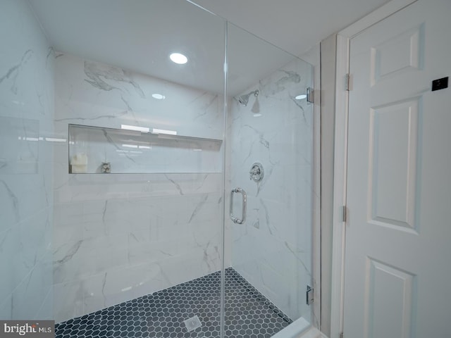 bathroom with a marble finish shower