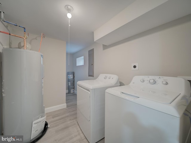 clothes washing area with washer and clothes dryer, water heater, laundry area, light wood-style flooring, and electric panel