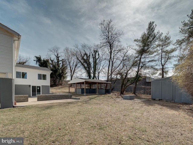 view of yard with a storage shed, a gazebo, an outdoor structure, and a patio