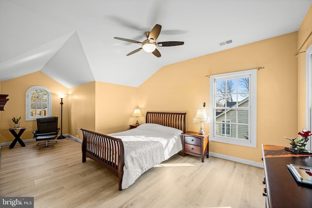 bedroom featuring visible vents, baseboards, vaulted ceiling, light wood-style flooring, and a ceiling fan