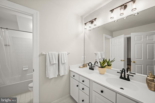 full bath with a sink, shower / bath combo with shower curtain, double vanity, and tile patterned floors