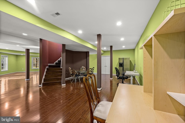 dining space featuring wood finished floors, visible vents, baseboards, recessed lighting, and stairs