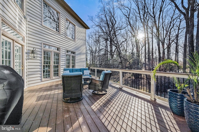 wooden terrace featuring grilling area and outdoor lounge area