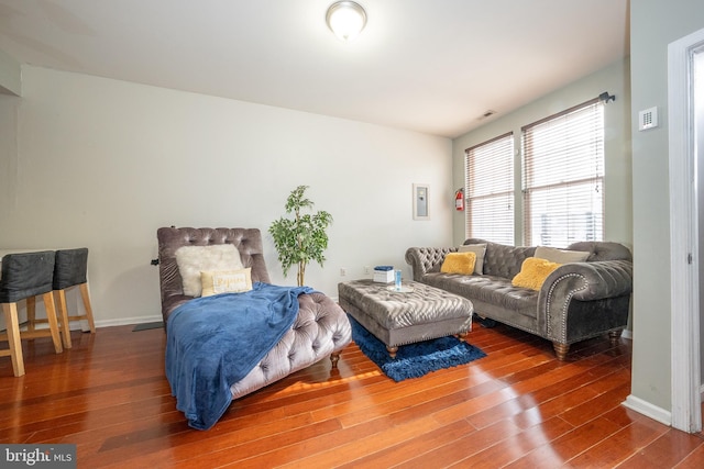 bedroom featuring visible vents, baseboards, and wood finished floors