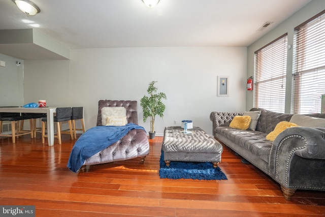 bedroom with wood-type flooring, visible vents, and electric panel