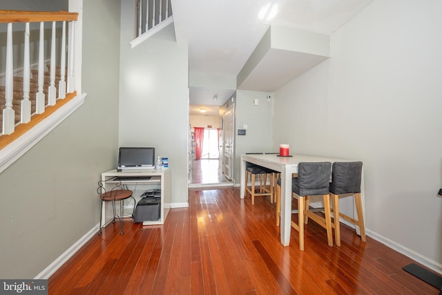 dining room featuring baseboards and hardwood / wood-style floors