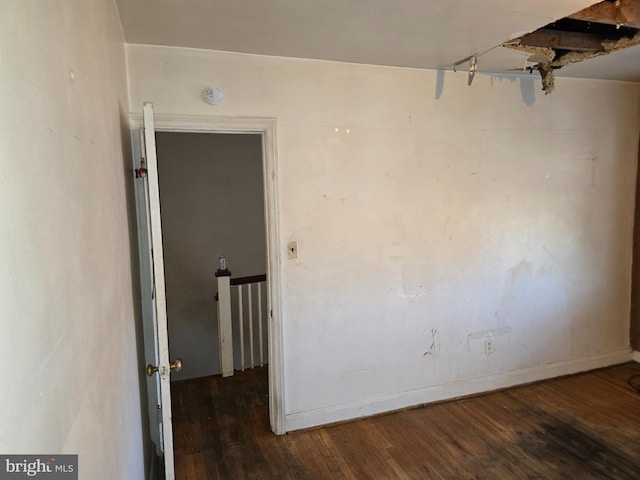 unfurnished room featuring dark wood-type flooring